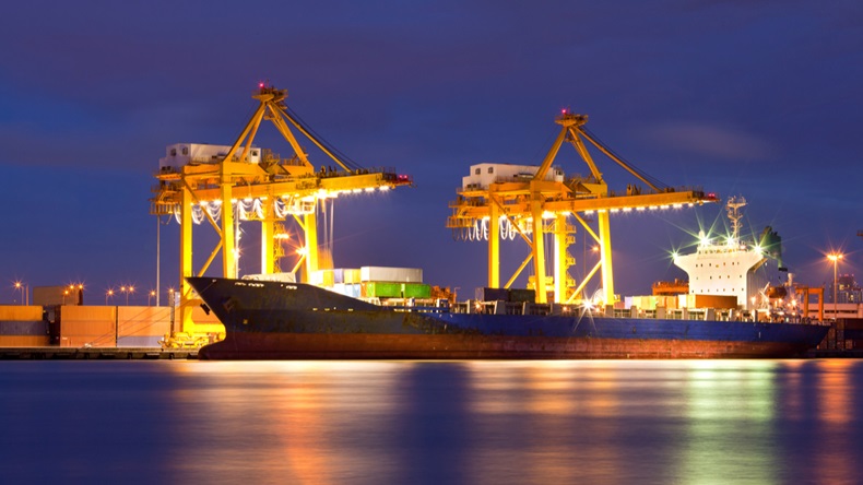 Cranes lit-up in a cargo port at night