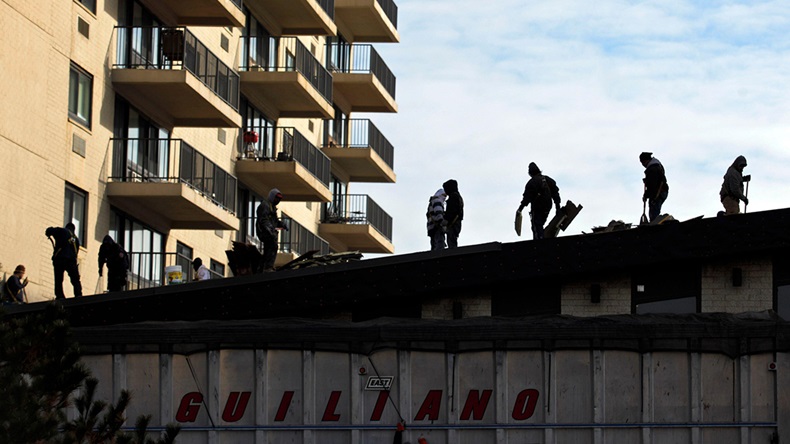 Roof repair (REUTERS/Eduardo Munoz/Alamy Stock Photo)