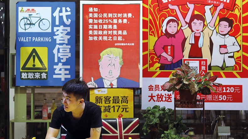 China tariffs poster (Color China Photo via AP)
