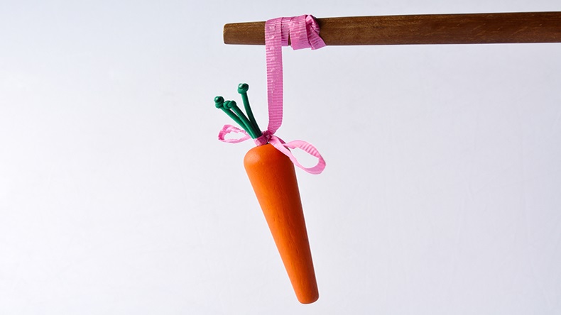 Carrot and stick (ChameleonsEye/Shutterstock.com)