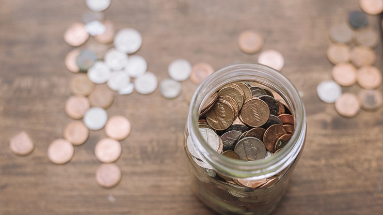 Coins in jar (Ben Harding/Shutterstock.com)