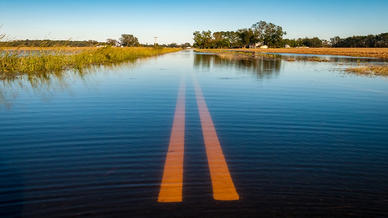 Flooded road (Moonborne/Shutterstock.com)