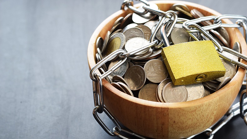 Trapped money (Unchalee Khun/Shutterstock.com)